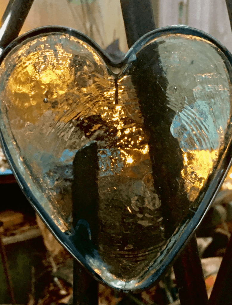 Glass heart detail in home-made metal gate