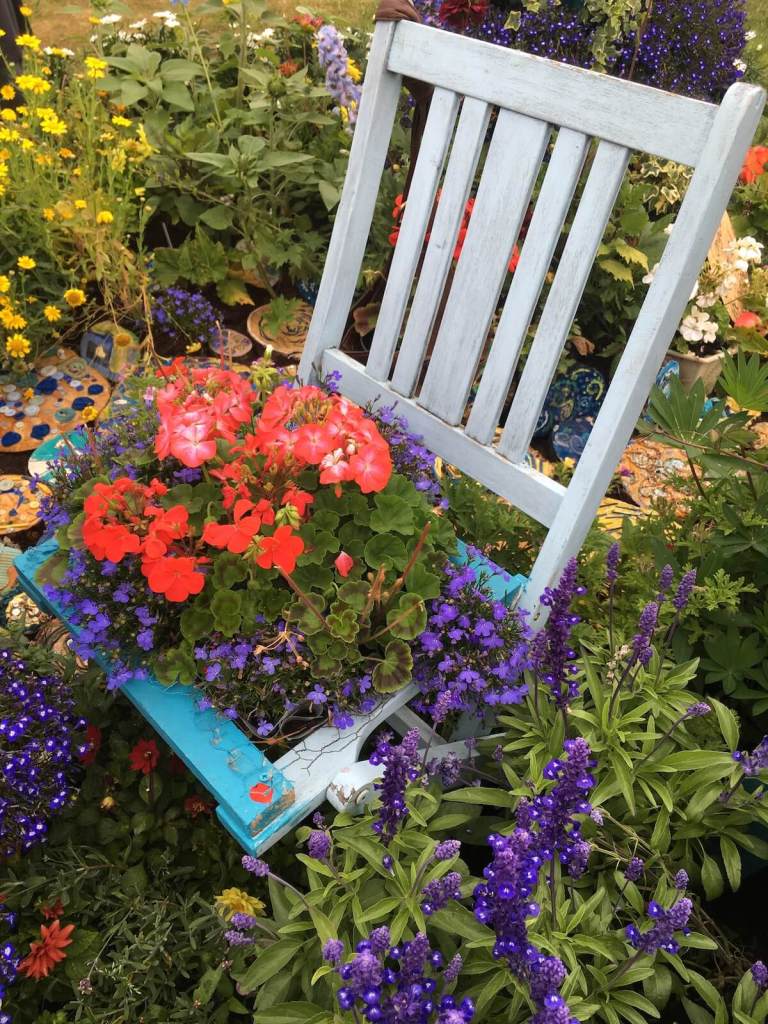 Chair with pelargonium flowers for a seat