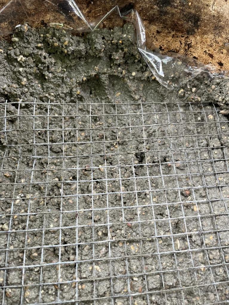 Hardware cloth strengthener pressed between layers of cement